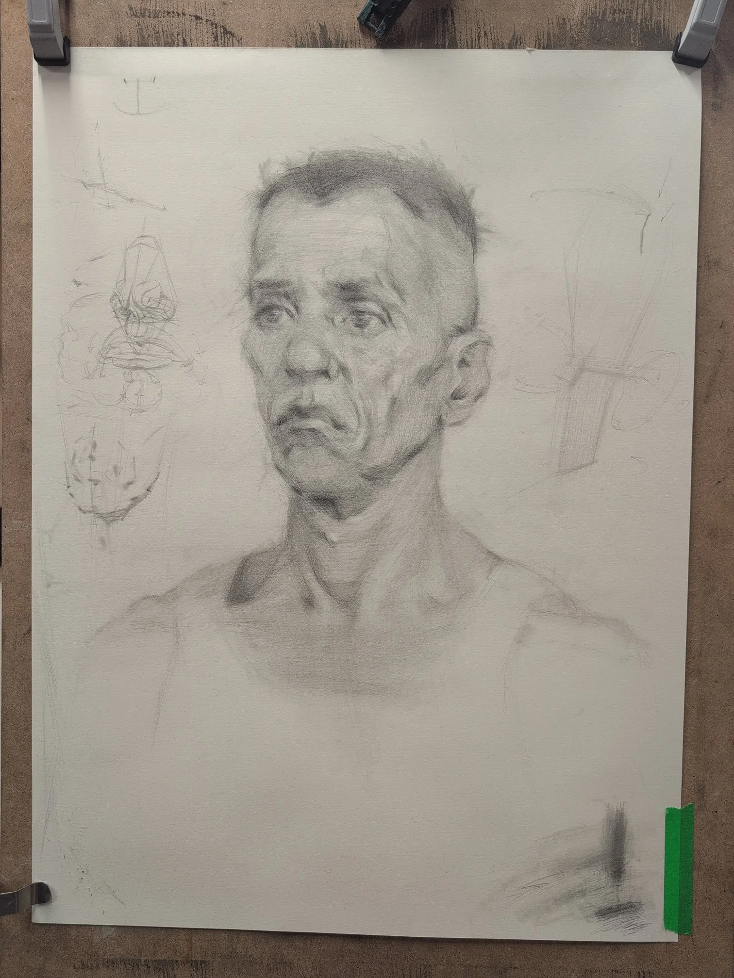 A pencil shaded drawing of a man in a vest